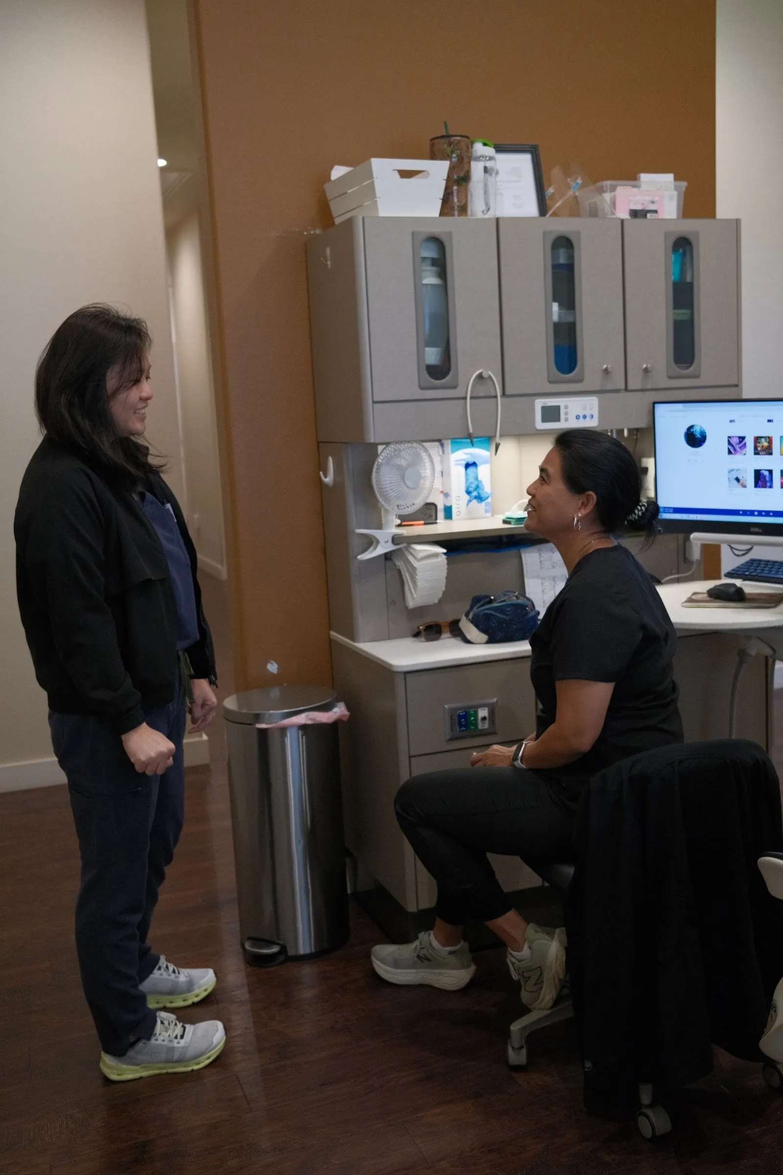 Dr. Han Nguyen talking with hygienist Maria about patient care at Hutto Hippo Family Dental