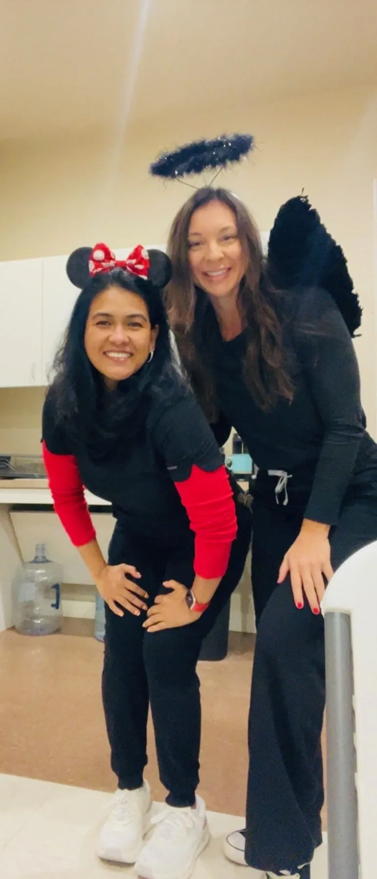 Two Hutto Hippo Family Dental team members dressed as Minnie Mouse and a dark angel